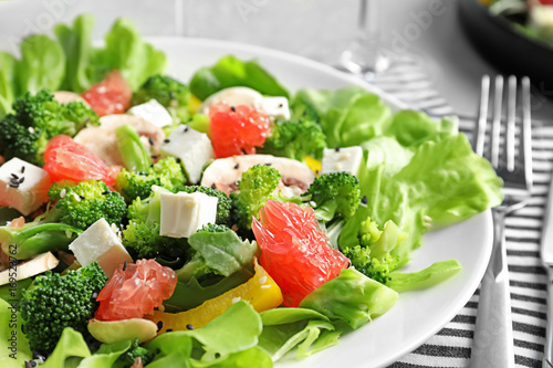 Plate with broccoli salad on table
