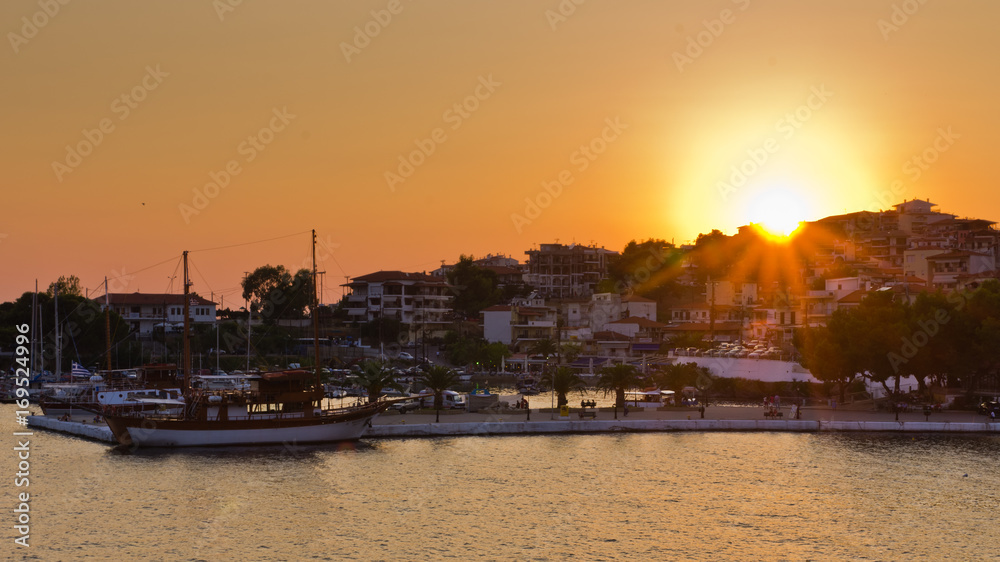 Ships in a harbor of Neos Marmaros at sunset in Sithonia, Greece
