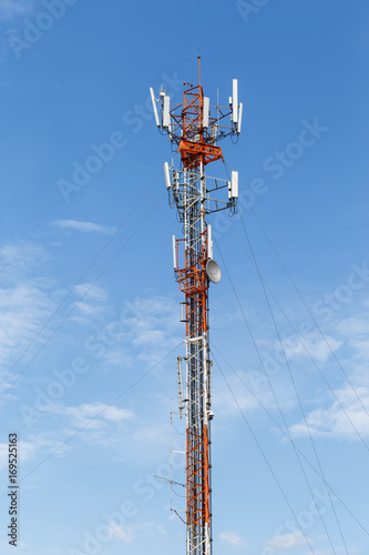 Telephone Pole Telecommunications Tower On Blue Sky Background.