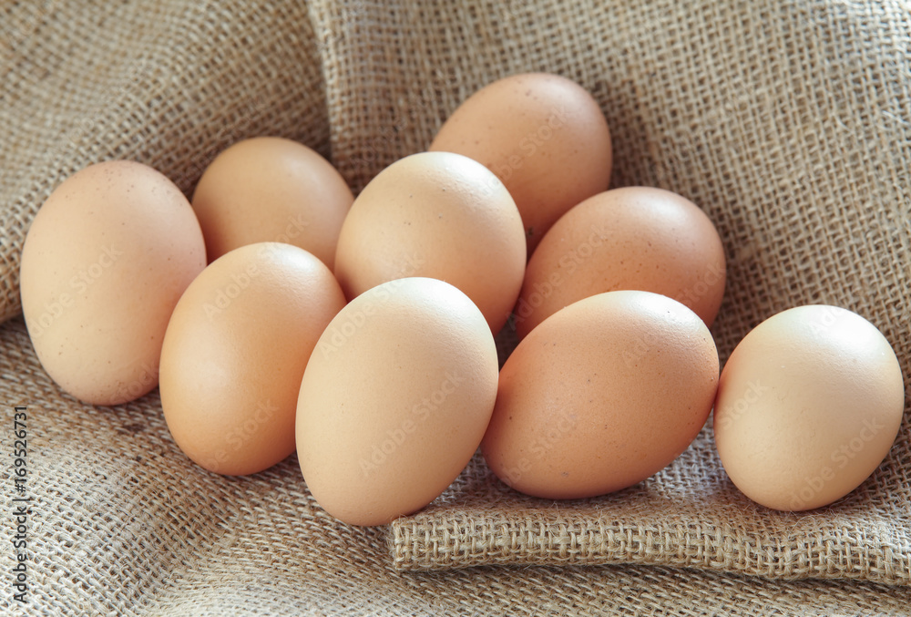 Pile of Brown fresh egg on brown fabric Pile of Brown fresh egg on brown fabric