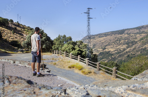 Trekker walking along Poqueira Gorge. Las Alpujarras Region  Granada  Spain