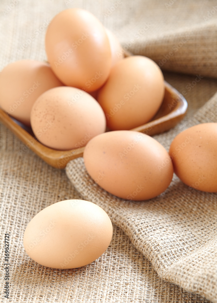 Pile of Brown fresh egg on brown fabric Pile of Brown fresh egg on brown fabric