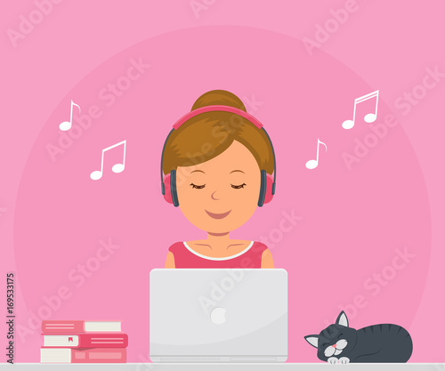 Cute girl with headphones listening to music and working on a laptop. Chat, dating, education, blogging and search for information on the network.