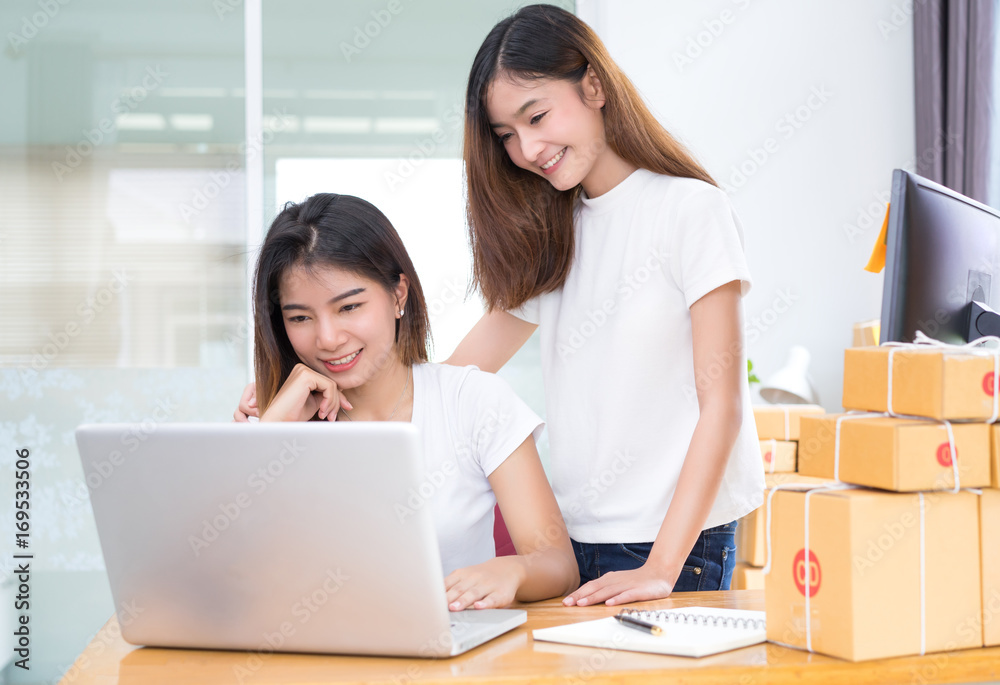 Young asian girl together teamwork freelancer small business private working at home office with laptop, note, phone, packaging delivery online market on purchase checking orders to customer. Young asian girl together teamwork freelancer small business private working at home office with laptop, note, phone, packaging delivery online market on purchase checking orders to customer.