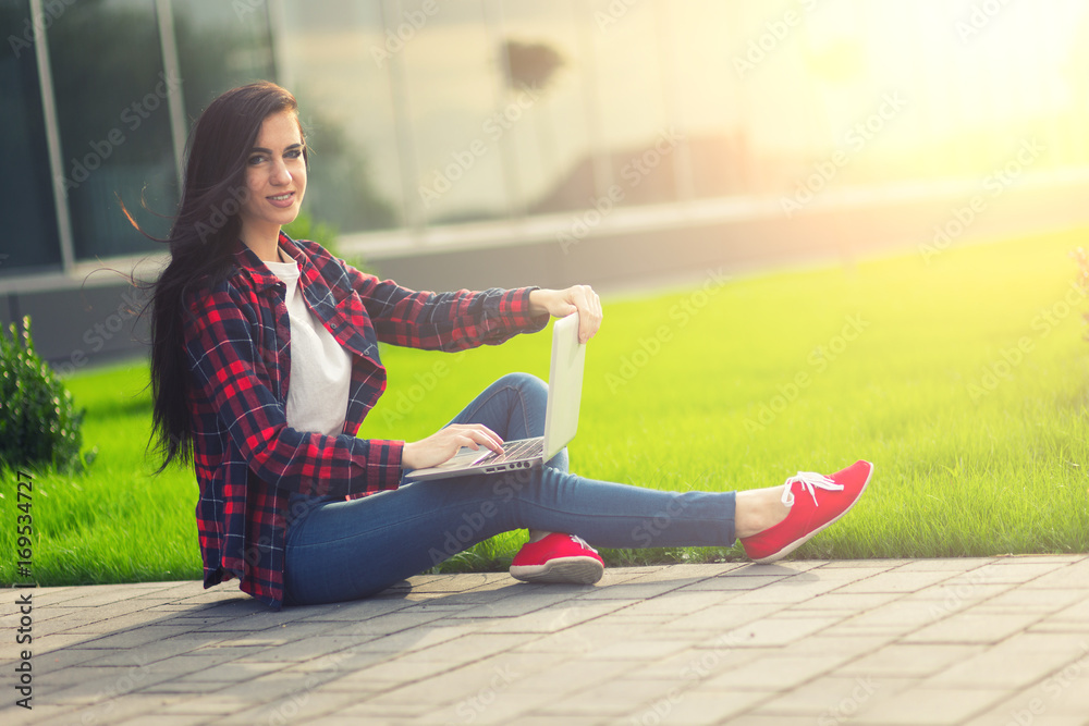 Young brunette woman student working outdoors Young brunette woman student working outdoors