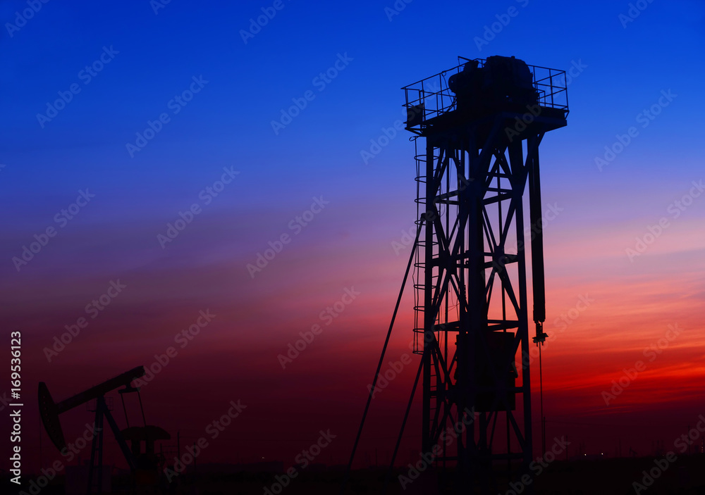 The pumping unit is working in the setting sun The pumping unit is working in the setting sun