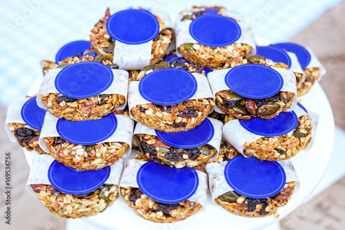 Cereals seeds cakes and biscuits in blue and white package, on white table, shallow focus close up