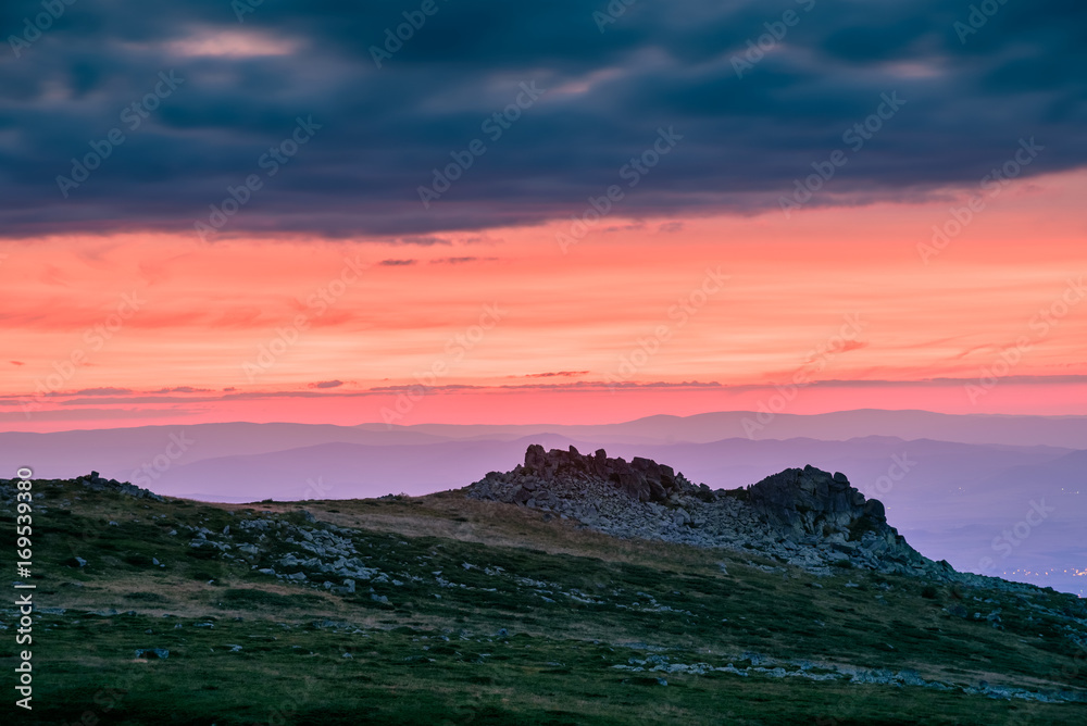 Amazing sunset over the mount of Vitosha, Bulgaria - colorful sky with dramatic dark clouds, over rocky outcrops