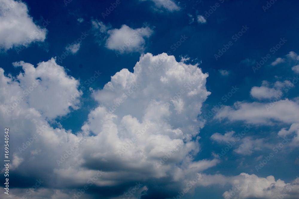 The white puffy clouds in the blue sky. The white puffy clouds in the blue sky.