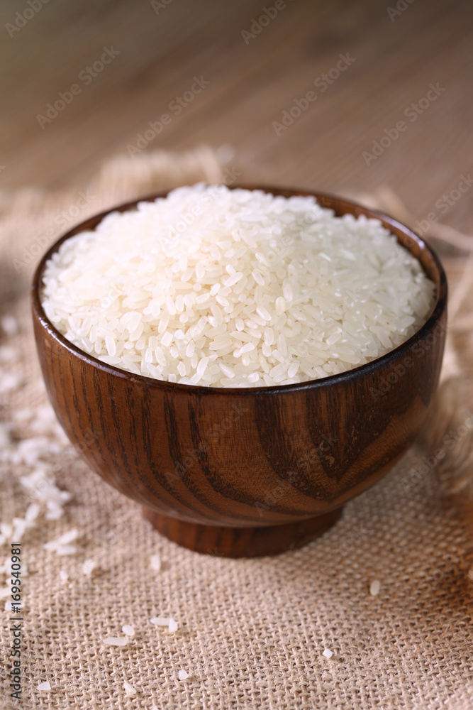 Close up of white rice in the wooden bowl. 