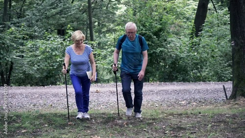 Senior man having injury after hiking in the park
