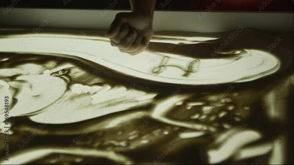 Drawing with sand. Short show. Drawing sand on a white screen. Sand Artist. Female hands are a major plan. Show at the wedding. Drawing with sand. Short show. Drawing sand on a white screen. Sand Artist. Female hands are a major plan. Show at the wedding.