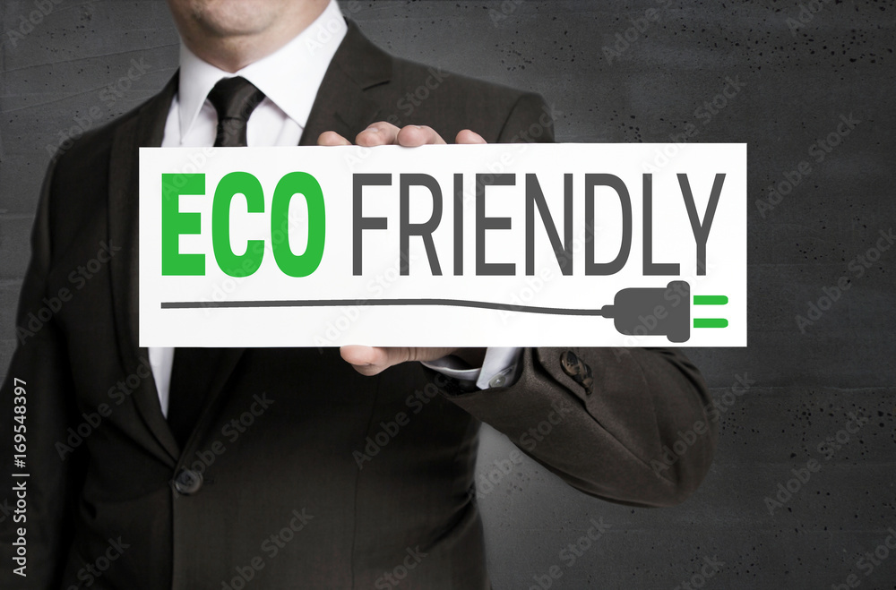 Eco friendly signboard is held by businessman Eco friendly signboard is held by businessman
