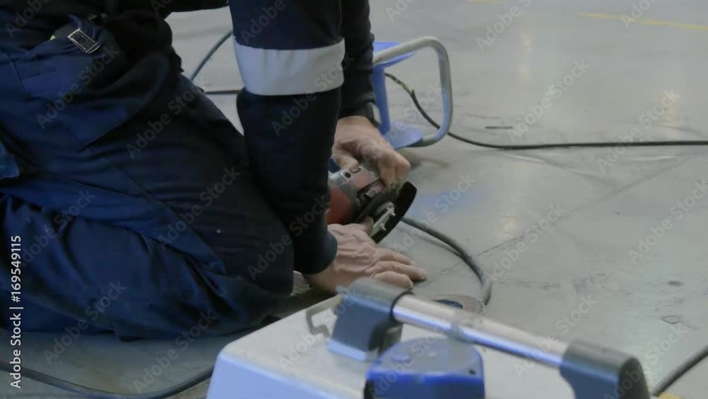 workers changing a disk from a radial saw workers changing a disk from a radial saw