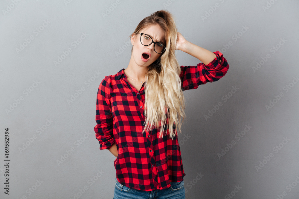 Shocked young blonde woman wearing glasses Shocked young blonde woman wearing glasses