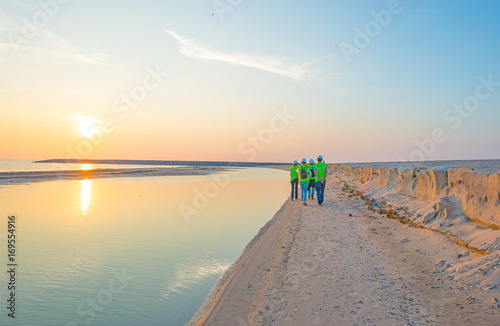 Artificial island under construction in a lake at sunset in summer