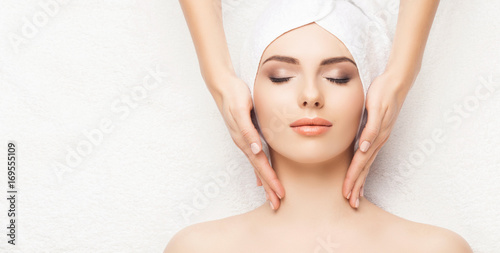 Portrait of a woman in spa. Massage healing procedure. Health care, skin lifting and medical concept. photo