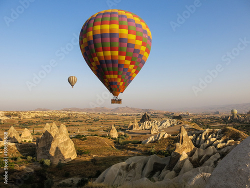 Hot air balloons over rock formations in Cappadocia, Turkey