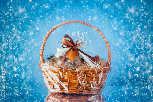 gift basket with festive particles, blue background photo