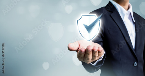 Fotografie Businessman holding shield protect icon, Concept cyber security safe your data