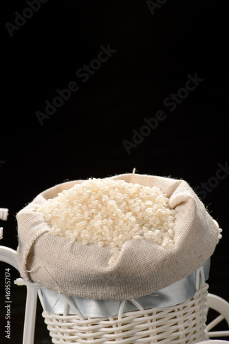 fulled rice in straw rice bag isolated on black background 