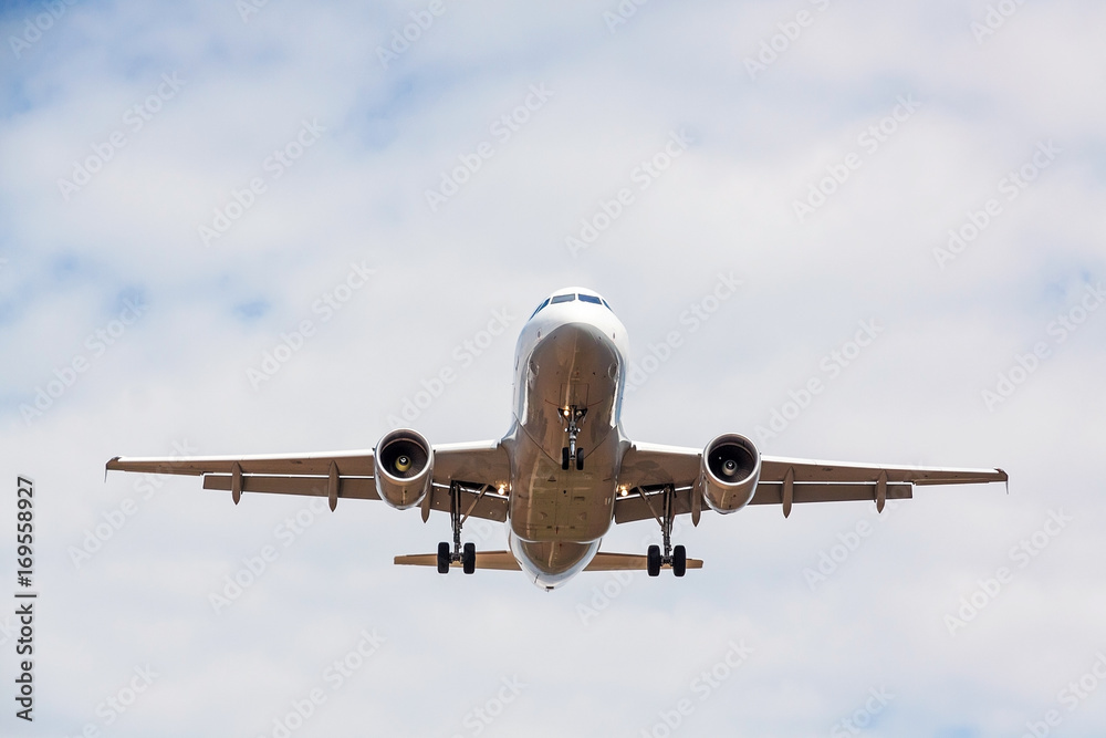 airplane flying overhead - landing / takeoff - blue sky with clouds airplane flying overhead - landing / takeoff - blue sky with clouds