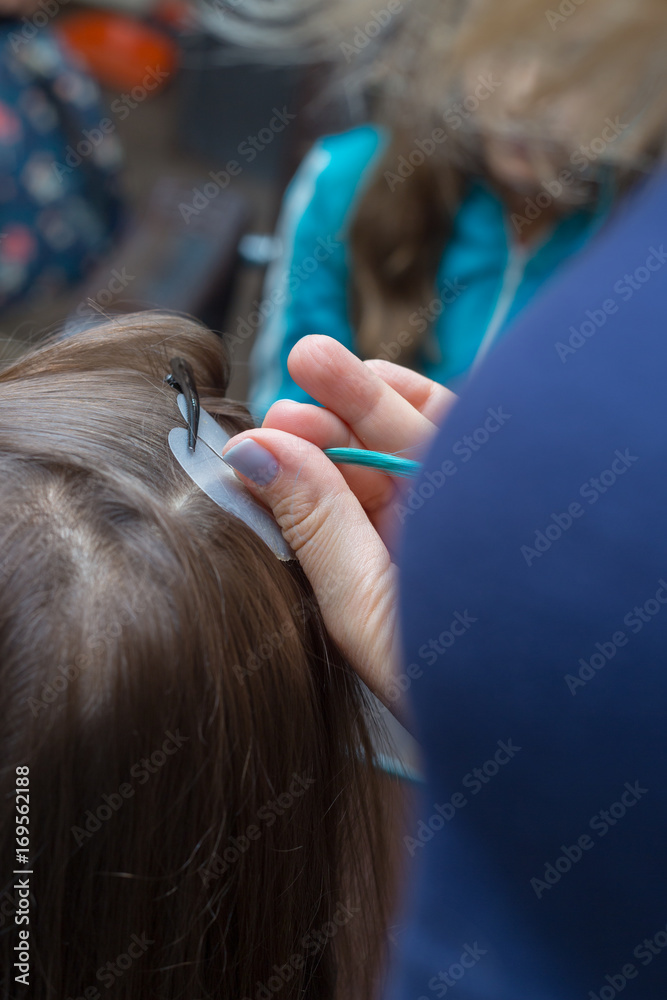 Fototapeta premium Haircut and the build-up of multicolored strands