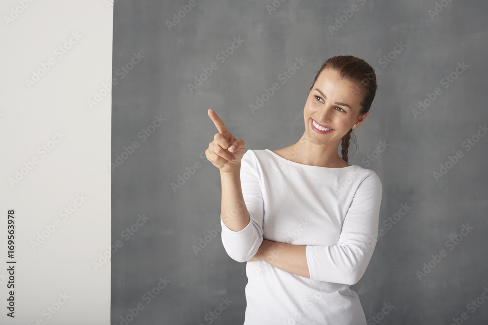 I show you something. Woman pointing up with her finger I show you something. Woman pointing up with her finger
