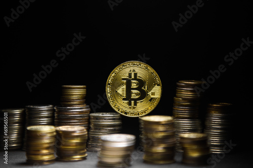 Golden bitcoin with money coins background. Bitcoin on black background photo