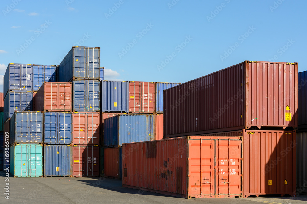 Dozens of dry cargo containers stacked in an intermodal port terminal. Dozens of dry cargo containers stacked in an intermodal port terminal.