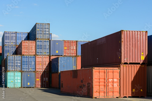 Dozens of dry cargo containers stacked in an intermodal port terminal.