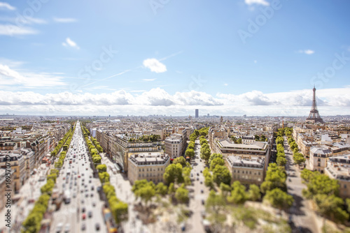Aerial wide angle cityscape view on the beautiful buildings with Eiffel tower on the background during the sunny day in Paris. Tilt-shift image technic © rh2010