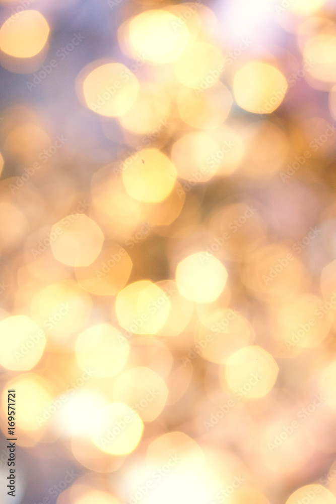 Fototapeta premium Golden Christmas background with natural bokeh and twinkled defocused lights. Festive blur background .