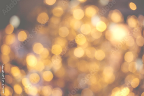 Golden Christmas background with natural bokeh and twinkled defocused lights. Festive blur background .