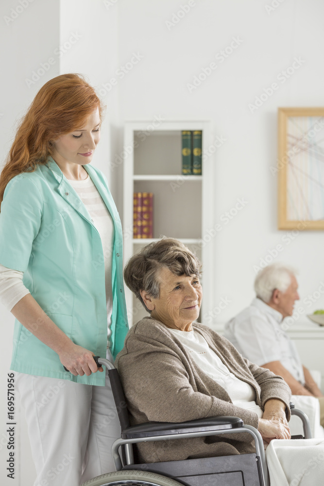 Fototapeta premium Assistant looks on elder woman