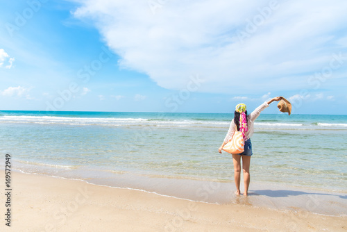 Happy and relax woman on the beach in summer day. Travel Concept