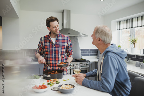 Father And Son Enjoying A Meal