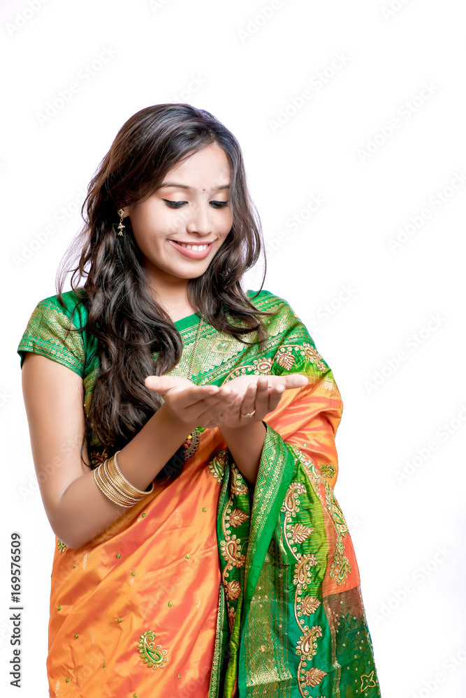 Happy young beautiful Indian woman in traditional saree