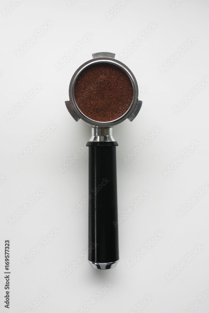 Espresso basket full of coffee grounds from above Espresso basket full of coffee grounds from above