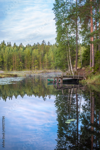 Tranquil morning view with pier and lake at early morning in Nuuksio National Park, Finland