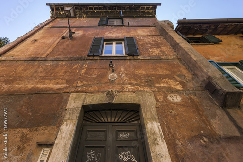 Old colorful facade walls and windows, grunge architectural background, Rome, Italy