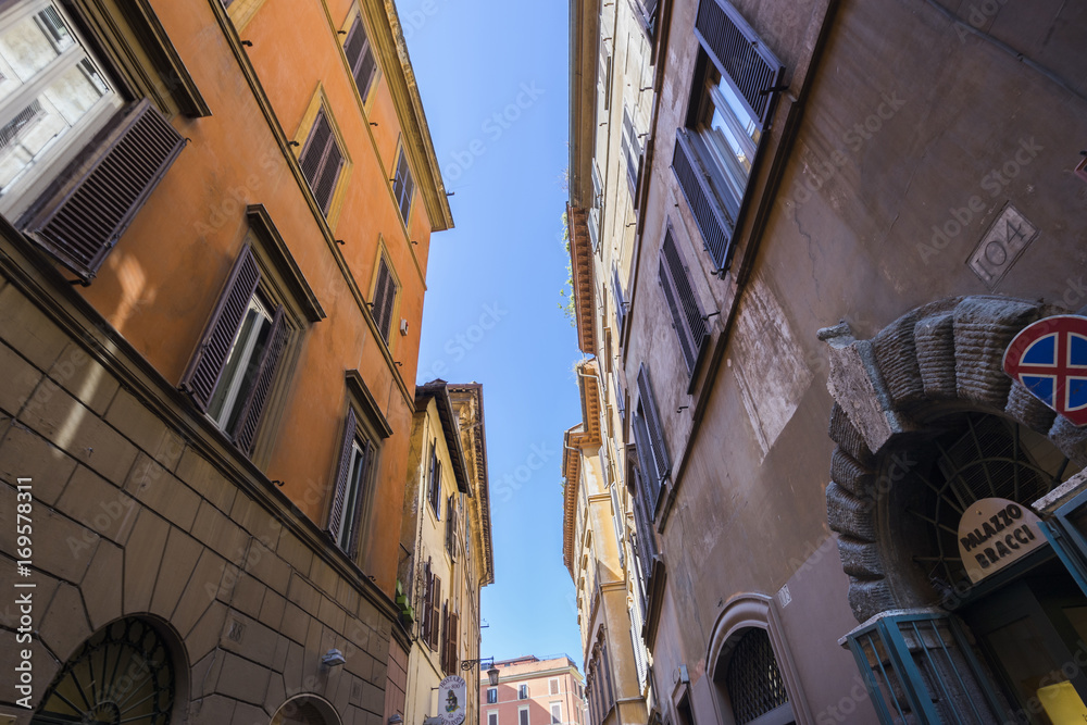 Small tiny street between old buildings in Rome. Front door of P