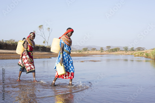 Women from Samburu tribe collecting water. Kenya, Africa