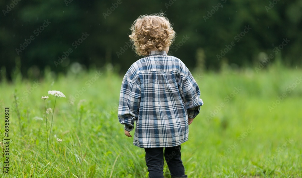 Young boy with curly hair playing outdoor Young boy with curly hair playing outdoor