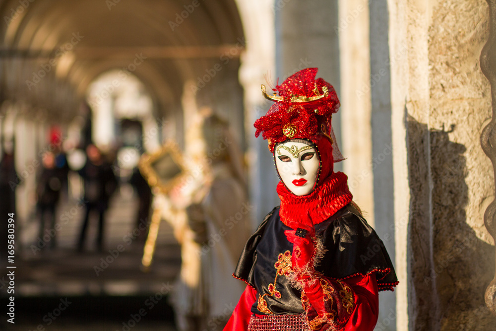 Costumed woman in Venetian mask during Venice Carnival in Venice