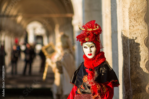 Costumed woman in Venetian mask during Venice Carnival in Venice