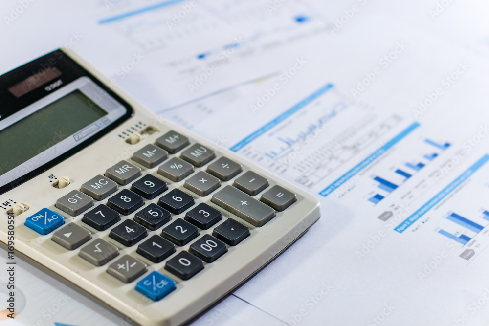 Close up business concept, Calculator on financial report on table office Close up business concept, Calculator on financial report on table office
