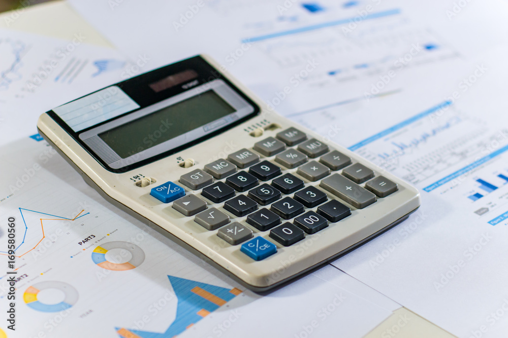 Close up business concept, Calculator on financial report on table office Close up business concept, Calculator on financial report on table office
