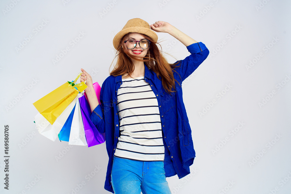 A woman with glasses and a hat keeps shopping, a smile, a shopaholic A woman with glasses and a hat keeps shopping, a smile, a shopaholic