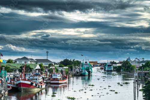 Many fishing boats docked in the canal.